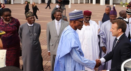 Muhammadu Buhari and other government officials welcoming visiting President Emmanuel Macron
